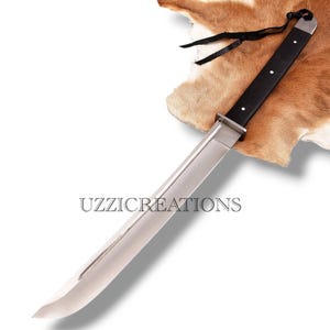 May include: A long, silver blade with a black handle and three white dots. The blade has a rectangular guard and is labeled with the text "UZZICREATIONS". The handle has a black leather strap.