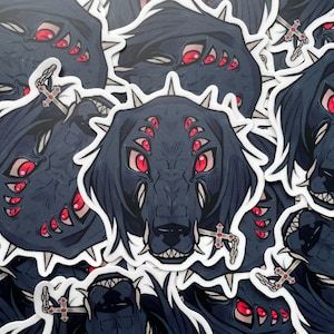 May include: A sticker sheet featuring multiple illustrations of a black dog with a hooded head and multiple red eyes. The dog is holding a cross in its mouth. The stickers are on a white background.