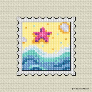 May include: Cross-stitch art piece depicting a beach scene within a postage stamp frame. The design features a pink starfish, blue and green waves, and a yellow sky with a sun and clouds. The background is a neutral beige.
