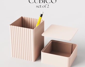May include: Set of two pink, ribbed, square storage containers. One container has a lid and the other has a yellow pencil inside.