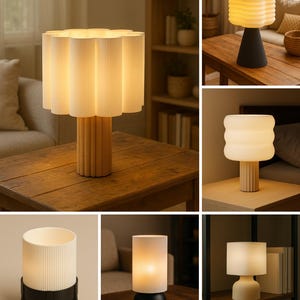 May include: A collection of table lamps featuring various designs, including fluted white glass shades and cylindrical or tapered bases in black, white, or wood-toned finishes. These lamps emit a warm, soft glow and display diverse textures.