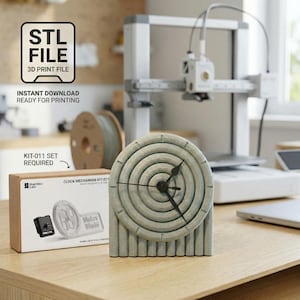 May include: A 3D-printed clock with a circular face and vertical base. The clock is light gray with black clock hands. The image includes a 3D printer, a spool of filament, and a box labeled "CLOCK MECHANISM KIT-011". Text reads "STL FILE 3D PRINT FILE" and "INSTANT DOWNLOAD READY FOR PRINTING".