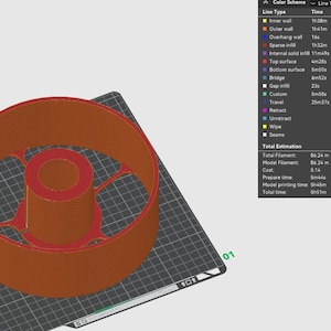 Puede incluir: Un modelo impreso en 3D de un objeto redondo con una abertura redonda m&aacute;s peque&ntilde;a en el centro. El modelo est&aacute; impreso en marr&oacute;n y se encuentra sobre una superficie negra texturizada. El modelo tiene un di&aacute;metro de 86,24 cm y pesa 257,21 gramos.