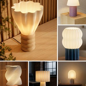 May include: A collection of six table lamps featuring various sculptural designs. The lamps include diverse shapes such as fluted, ribbed, and twisted shades paired with bases in colors like light wood, mauve, blue, pink, and white, all emitting a warm glow.
