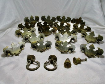 A Twenty-two Piece Vintage Colonial Style Brass Tone Dresser Drawer Pulls & Knobs from Three Pieces of Bedroom Furniture.