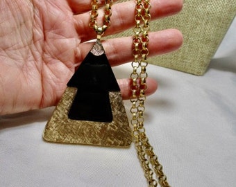 A Vintage SARAH COVENTRY Large,Shimmering Simulated Black Onyx & Gold Tone Triangular Pendant on a Gold Tone Chain.