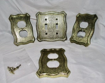 A Four Piece Set of AMERICAN TACK & HARDWARE 1968 Gold Tone Outlet Covers and Light-switch Cover.\