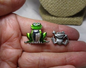 A Pair of Happy, Hopping Frog Pins in Pewter by J.J. and a Silver Tone Froggy with Shiny Green Enamel.