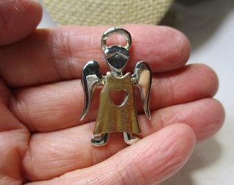 A Cute Little SIlver and Gold Tone Angel Pin/Brooch with a Heart Cutout in the Center of Her Robe.