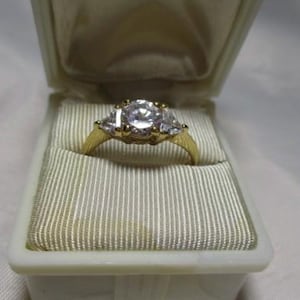 1990&#39;s Simulated Diamond Solitaire Ring with Triangle Accent Stones on Each Side in a Yellow Gold Tone Size 8.