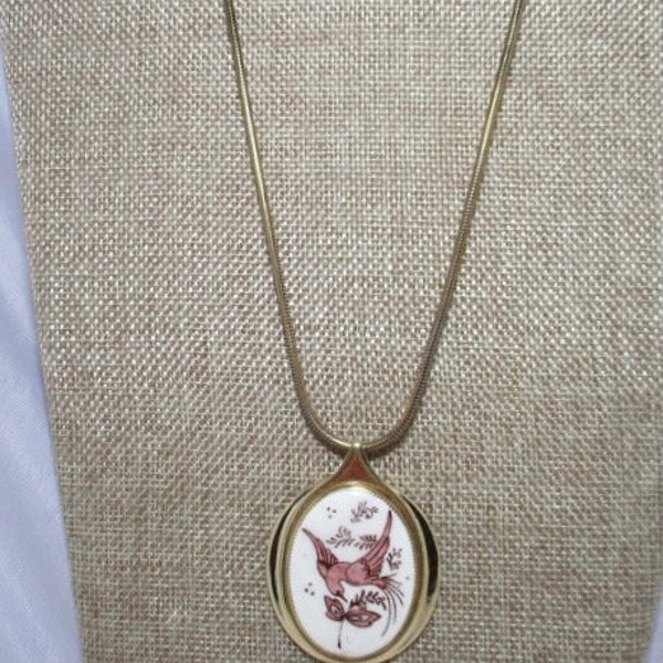 A Vintage WHITING & DAVIS Ceramic Bird Pendant on a Long Gold Tone Chain.