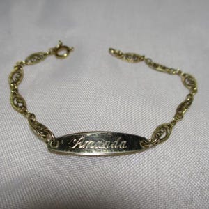 A 1970&#39;s Child&#39;s Girls Engraved ID Bracelet with AMANDA in Cursive Script Writing in 1/20 14 K Gold Filled.