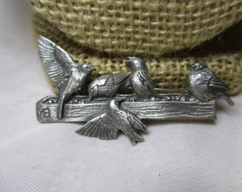 A 1999 MARGORIE BASTIN Pewter Birds at the Feeder Brooch/Pin.