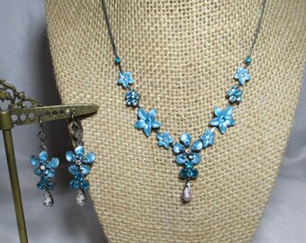 A 1998 Set of Turquoise & Peacock Blue Necklace and Earrings with Shimmering Colored Rhinestone Accents.