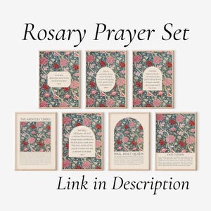 May include: A set of seven rectangular wall art prints titled Rosary Prayer Set. Each print features a dark blue background with pink and red floral patterns. The prints contain printed prayers including The Apostles' Creed, Hail Mary, and Our Father.