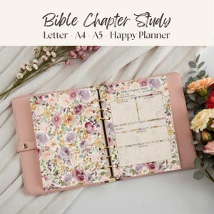 May include: A pink ring-bound planner open to a Bible Chapter Study page. The left side features a floral pattern with purple, yellow, and cream flowers. The right side includes sections for Key People, Key Verses, Themes, Questions, and Summary.