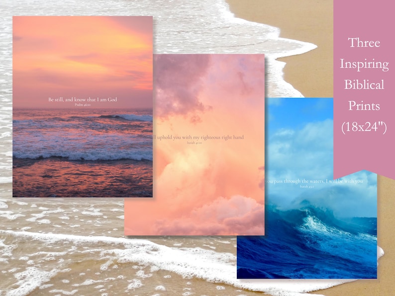 Three 18x14-inch poster prints with inspirational bible verses set against coastal scenes. The first print features a pink and orange sunset over the ocean with the verse 'Be still, and know that I am God.' The second print features a pink and orange cloudy sky with the verse 'I will Uphold you with my righteous right hand.' The third print features a blue ocean wave with the verse 'when you pass through these waters, I will be with you.'