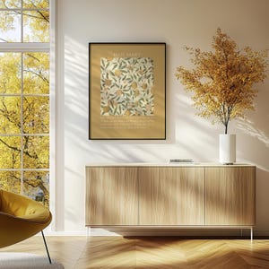 May include: A framed wall art print featuring the text HAIL MARY at the top, a central botanical illustration of oranges and green leaves on a cream background, and prayer text at the bottom, all set against a solid mustard yellow border.