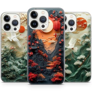 Könnte beinhalten: Drei iPhone-Hüllen mit einem Papierkunst-Design. Die Hüllen zeigen einen weißen Kranich, eine rote Sonne und eine Berglandschaft. Die Hüllen sind alle weiß mit einem durchsichtigen Rücken.