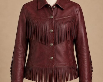 May include: A deep burgundy jacket featuring a pointed collar, long sleeves with cuffs, and a front button closure. The garment is detailed with horizontal fringe trim across the chest and vertical fringe trim along the hem and sleeves.