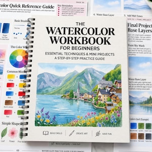 May include: A spiral-bound workbook titled The Watercolor Workbook for Beginners, featuring a watercolor illustration of a lakeside village with mountains, a lake, and colorful flowers. The cover includes text, icons, and instructional guides.