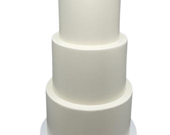May include: A three-tiered white wedding cake with smooth frosting. The cake is on a white cake board.