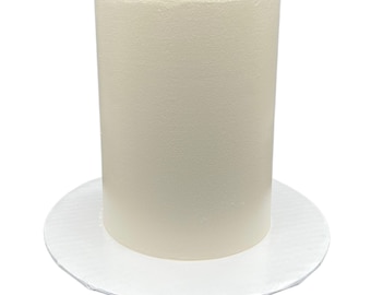 May include: A white round cake dummy with a white cardboard base. The cake dummy is a cylinder shape and is used for cake decorating practice.
