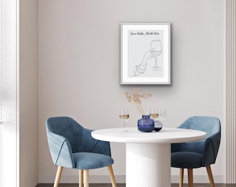 May include: A white framed print with a black line drawing of a hand holding a glass of wine. The text "Save Water, Drink Wine" is above the drawing.