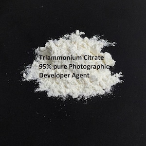 May include: A white powder labelled "Triammonium Citrate 95% pure Photographic Developer Agent" against a black background.