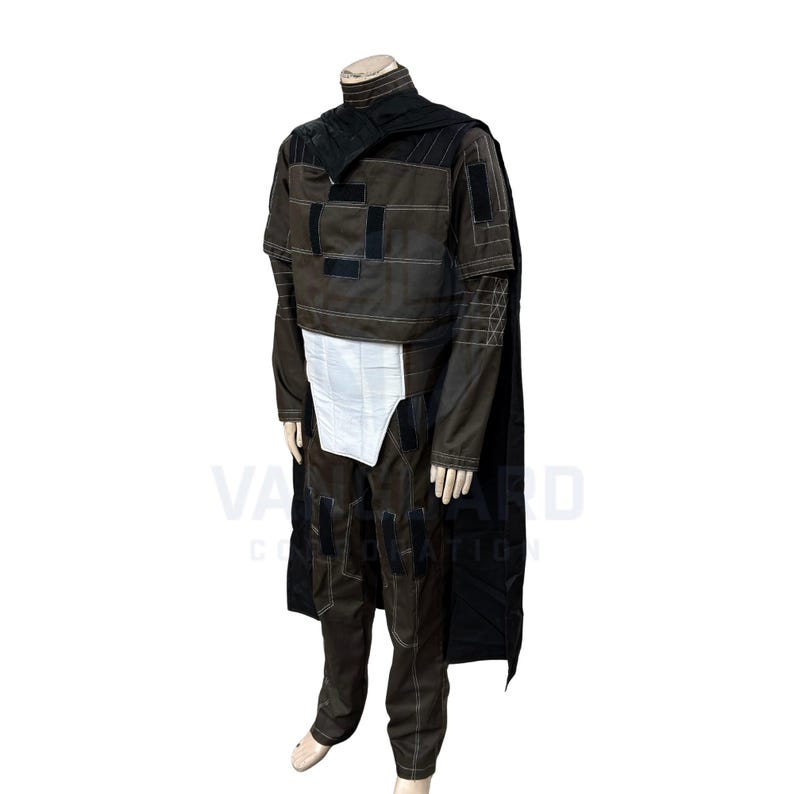May include: A full-body costume with a brown jacket, pants, and a black cape. The jacket has black patches and white stitching. A white panel is visible at the waist. The costume is displayed on a mannequin.