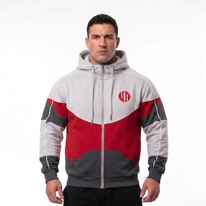 Könnte beinhalten: Ein grauer, roter und anthrazitfarbener Kapuzenpullover mit Reißverschluss, Kapuze und einem roten kreisförmigen Logo auf der Brust. Der Hoodie hat weiße Zierleisten und einen durchgehenden Reißverschluss. Das Design weist Farbblock-Panels und eine sportliche Ästhetik auf.