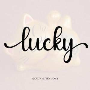 May include: A digital graphic featuring the word lucky in a black cursive script font centered on a light pink background. The text INTRODUCING appears in small black capital letters above, and HANDWRITTEN FONT appears below the main word.