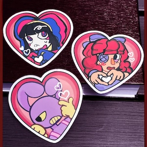 May include: Three heart-shaped stickers featuring cartoon characters. One shows a figure with black hair and blue clothing, another a figure with red hair and a purple bow, and the third a purple rabbit-like character, all making heart hand gestures.