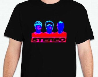 May include: Black t-shirt with a graphic of three blue and pink heads with the word "STEREO" in red letters.