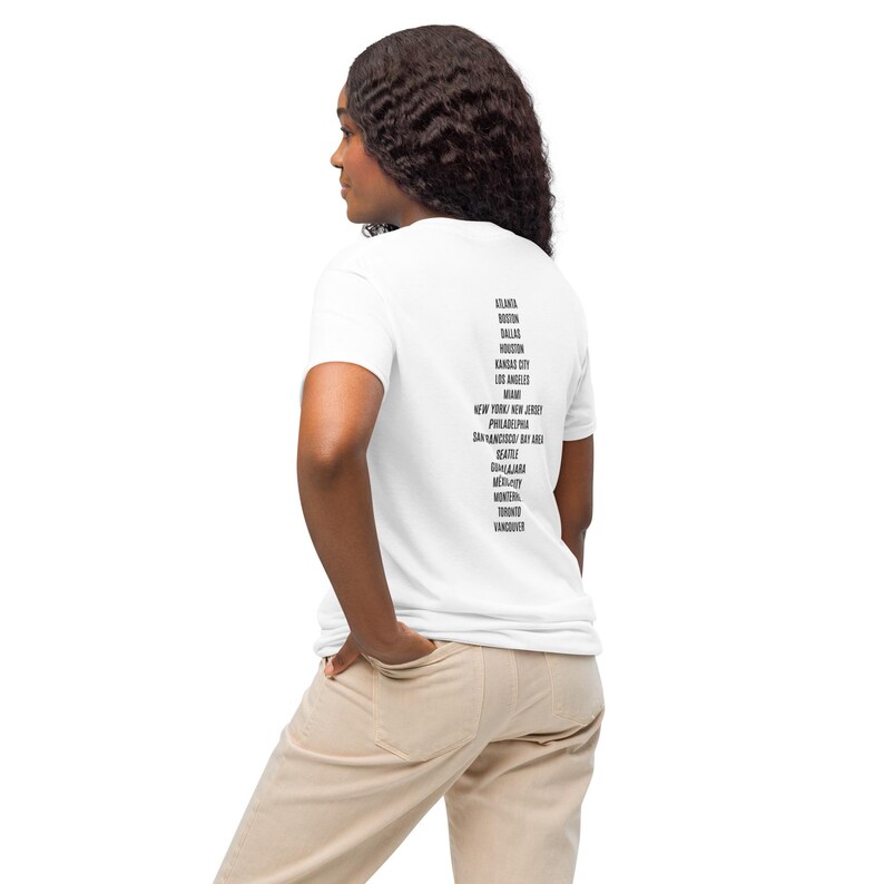 May include: White t-shirt with black text listing various cities, including Atlanta, Boston, Dallas, Houston, Kansas City, Los Angeles, Miami, New York, New Jersey, Philadelphia, San Francisco Bay Area, Seattle, Denver,  Milwaukee, Montreal, Toronto, and Vancouver.