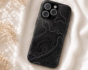 May include: A black smartphone case featuring a white topographic map line pattern across the entire back surface. The case has a rectangular camera cutout at the top left corner, revealing three circular camera lenses and a small flash component.