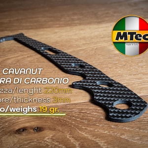 May include: A black carbon fiber tool with a textured pattern, featuring a curved design with multiple holes. The text on the image reads "CAVANUT" and "220mm length, 3mm thickness, weighs 19 gr."
