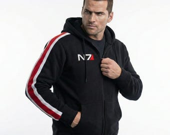 May include: A black zip-up hoodie featuring a white and red N7 logo on the left chest. The sleeves are accented with a vertical white stripe bordered by red stripes. The garment includes a drawstring hood and two front pockets for storage.