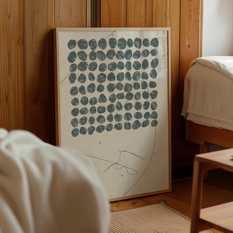 May include: A framed print with a minimalist design featuring a grid of blue circles on a white background. The print has a subtle, hand-drawn line in the bottom right corner.