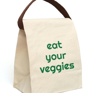 Canvas off white lunch bag. Reusable. It has a brown handle. It has a very simple look. Written on it in grass green letters it says "eat your veggies" in all lower case retro font. Great gift.