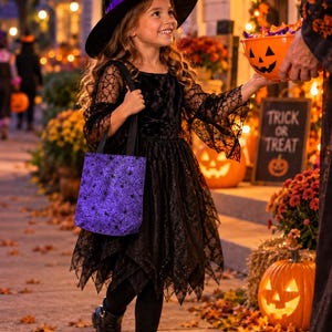 A young girl in a witches costume out trick or treating carrying a purple with spiders and webs Trick or Treat bag.