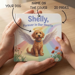 May include: A personalized pet memorial book with the name "Shelly" on the cover. The cover features an illustration of a dog with angel wings and a halo, set against a rainbow background. The book has 20 pages.