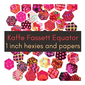 May include: A collection of 1-inch fabric hexagons in various shades of pink, red, orange, and purple with diverse patterns. A dark rectangular banner across the center displays the text: Kaffe Fassett Equator 1 inch hexies and papers.