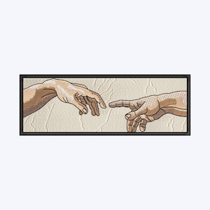May include: Embroidered patch featuring a detailed depiction of Michelangelo's 'The Creation of Adam' from the Sistine Chapel ceiling. The patch shows two hands nearly touching, with tan and brown tones, set against a textured beige background, framed in black.