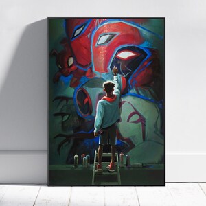 May include: A framed art print featuring a graffiti-style mural of superhero characters. A person on a ladder is depicted painting the mural with spray paint cans at their feet. The artwork is dominated by red, blue, and green hues.