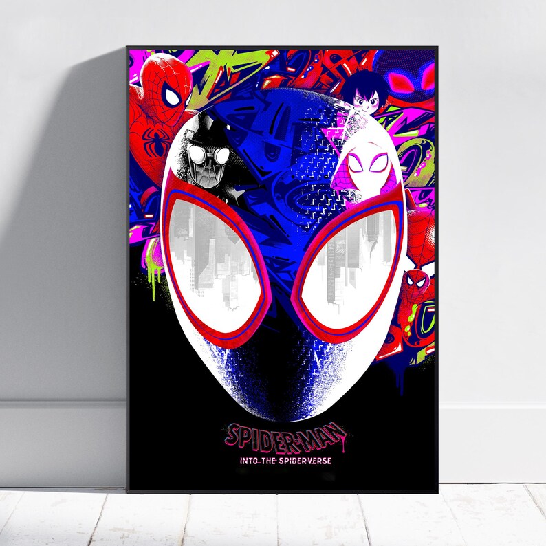 May include: A framed poster featuring a stylized illustration of Spider-Man's mask, with a white face and red-outlined eyes. The background is a vibrant mix of graffiti art in red, green, and blue, with the text "SPIDER-MAN INTO THE SPIDERVERSE".