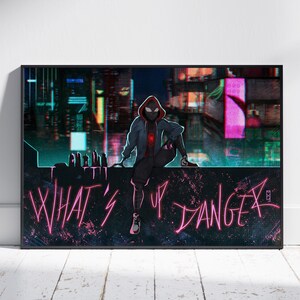 May include: A framed art print featuring a character in a black and red suit, sitting on a ledge with the words "WHAT'S UP DANGER" in pink neon. The background shows a cityscape with colorful lights.