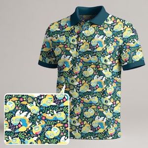 May include: A short-sleeved polo shirt with a whimsical pattern of yellow, blue, and white cartoon creatures on a dark teal background. The shirt has a teal collar and sleeve trim. A matching pattern swatch is in the lower left corner.