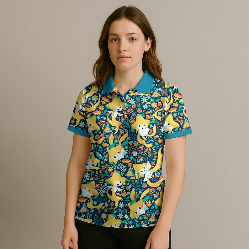 May include: A short-sleeved polo shirt with a vibrant pattern of yellow cartoon characters, flowers, and foliage on a navy blue background. The shirt has a teal collar and sleeve trim. The model is wearing black pants.