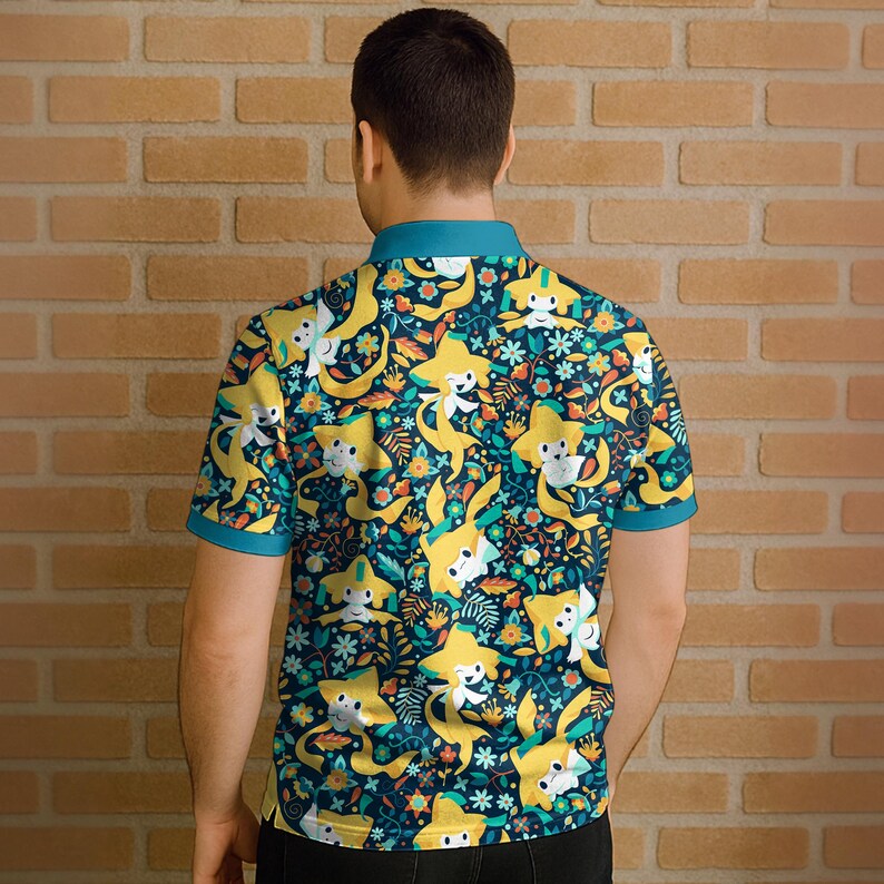 May include: A short-sleeved polo shirt featuring a repeating pattern of yellow star-shaped characters with white faces, set against a dark teal background with floral and leaf accents. The shirt has a teal collar and sleeve trim.